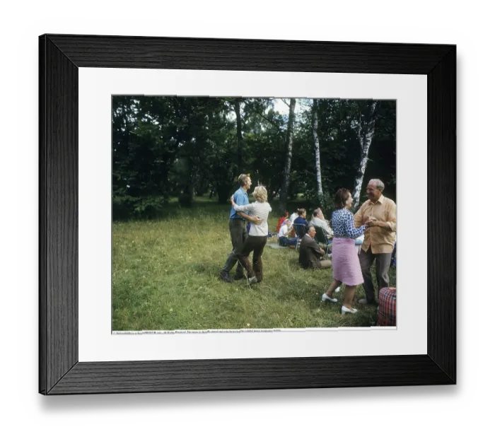 Framed Print : Dancing in the 1970s. Its a summer day and the dancing take place outdoors on the grass