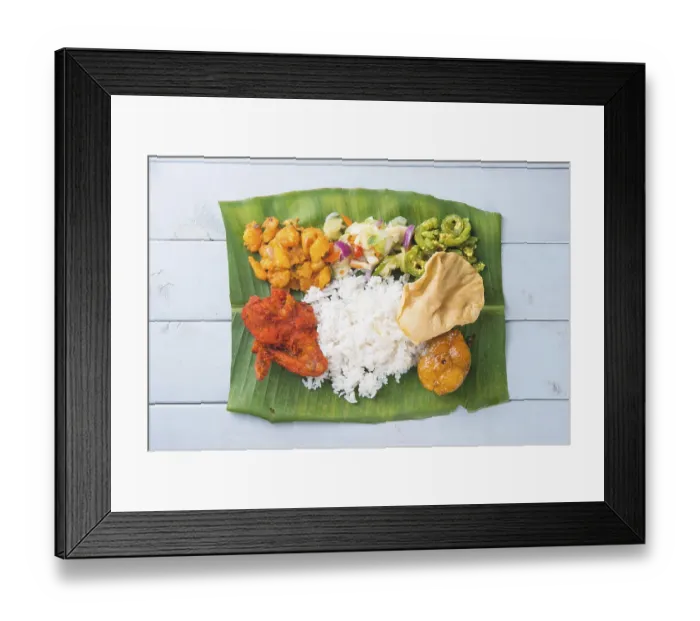 Framed Print : Indian banana leaf rice, overhead view on wooden dining table