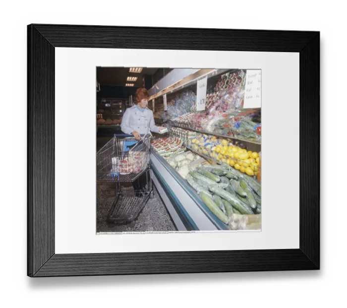 Framed Print : Shopping 1971. A woman shops in a self service store Framed Print : Shopping 1971. A woman shops in a self service store