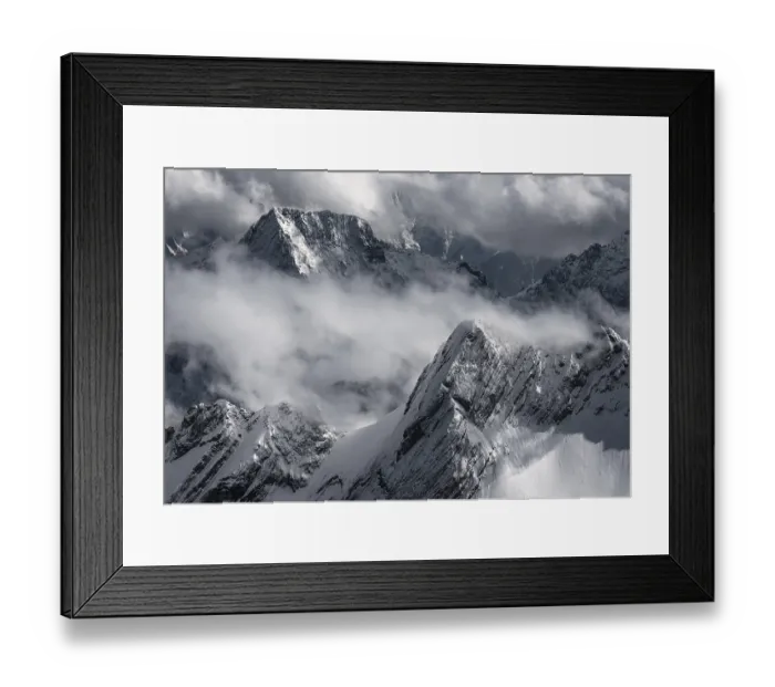 Framed Print : Snow-capped mountains and clouds create a dramatic atmosphere Framed Print : Snow-capped mountains and clouds create a dramatic atmosphere