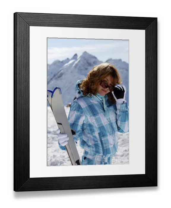 Framed Print : The happy girl in a blue ski suit on a background of mountains Elbrus