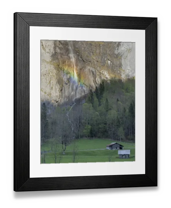 Framed Print : Rainbow-lit Waterfall Cascading Down Rocky Cliff Above Alpine Meadow in the Swiss Alps Framed Print : Rainbow-lit Waterfall Cascading Down Rocky Cliff Above Alpine Meadow in the Swiss Alps