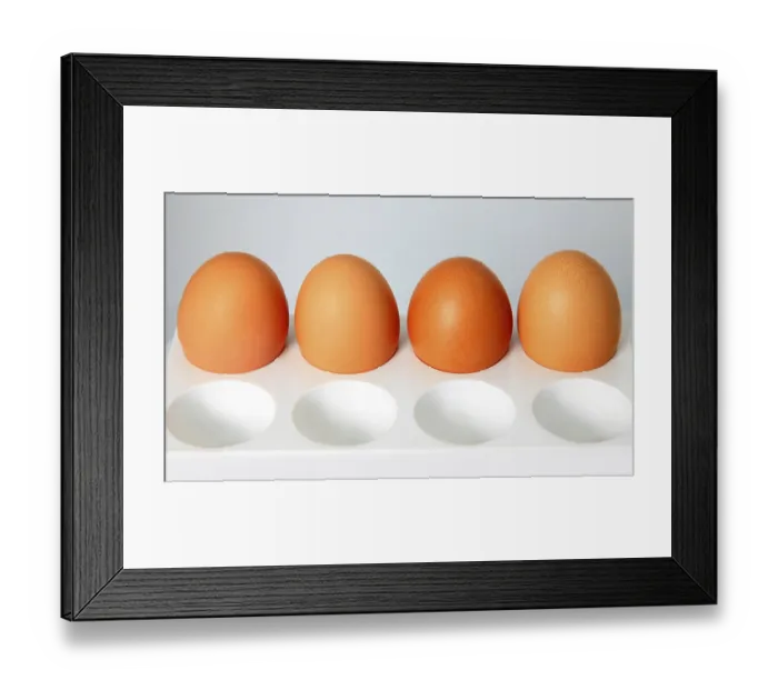 Framed Print : Four brown eggs in cells on a grey background Framed Print : Four brown eggs in cells on a grey background