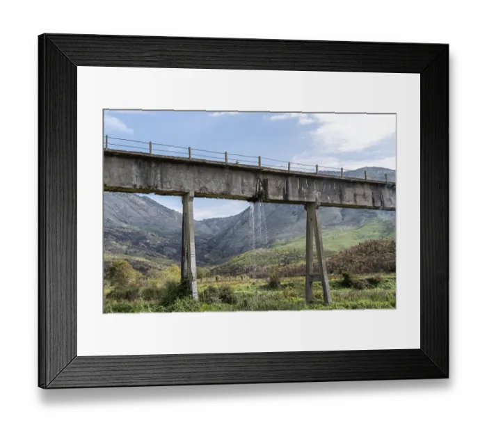 Framed Print : Leaky aqueduct with waterfall against mountain backdrop Framed Print : Leaky aqueduct with waterfall against mountain backdrop