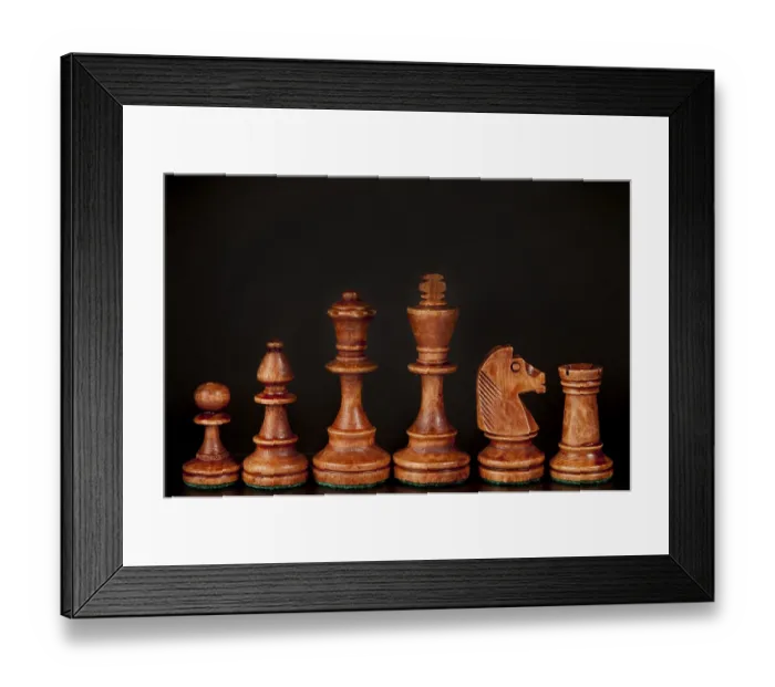 Framed Print : Wooden chess pieces lined up against a dark background