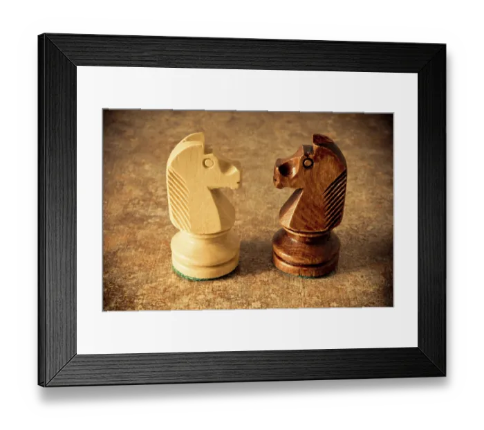 Framed Print : Two wooden knight pieces facing each other on a textured surface Framed Print : Two wooden knight pieces facing each other on a textured surface