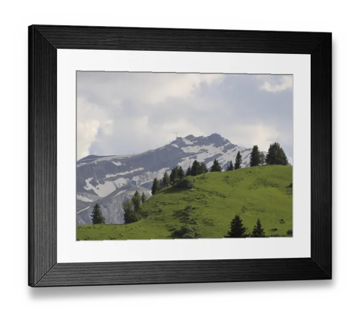 Framed Print : Green mountain meadow and suspension bridge connecting two peaks