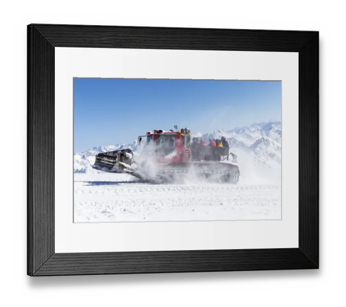 Framed Print : Snowcat on a slope high up in the mountains