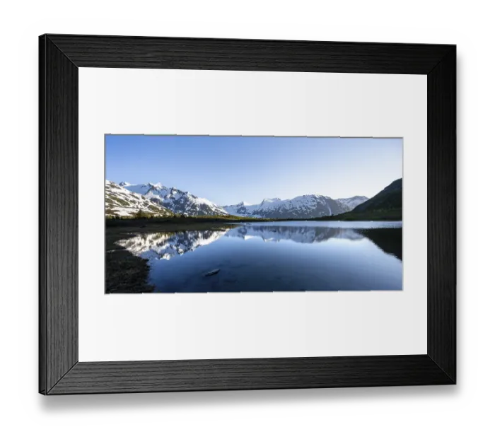 Framed Print : Mountain peaks with Portage Glacier glacier and snow reflected in Divide Lake mountain lake in evening light