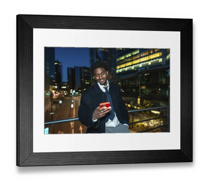 Framed Print : Young black businessman on an elevated walkway at night Framed Print : Young black businessman on an elevated walkway at night