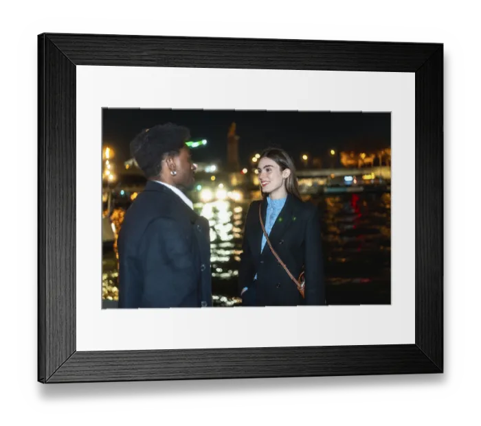 Framed Print : Young diverse couple standing by paris river at night