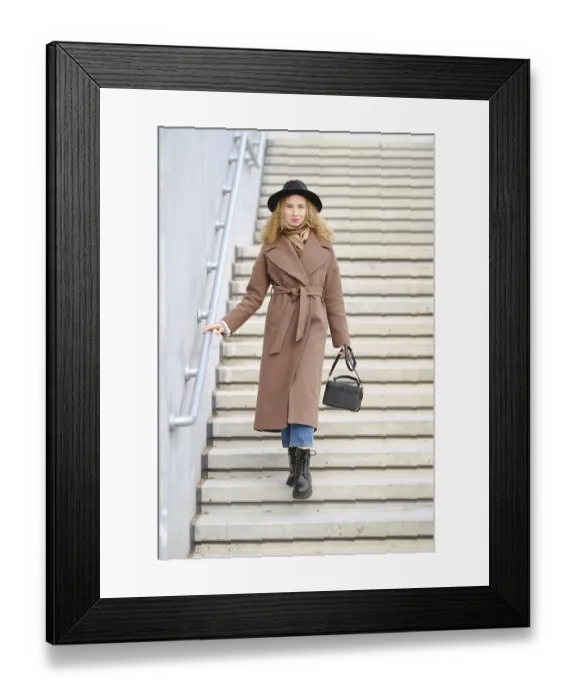 Framed Print : A woman walks down a set of steps in an urban location