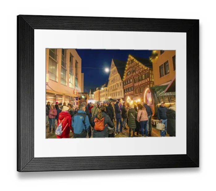 Framed Print : People enjoy the busy Christmas market in a half-timbered house town at night
