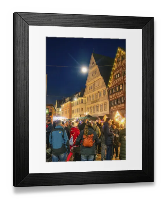 Framed Print : Evening Christmas market with illuminated half-timbered houses and crowd of people in the center