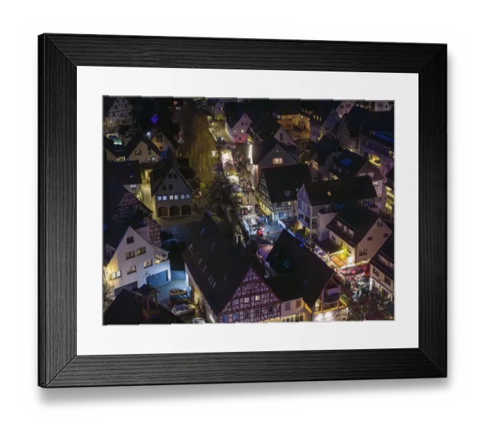 Framed Print : Night view of a village with illuminated half-timbered houses and roads Framed Print : Night view of a village with illuminated half-timbered houses and roads