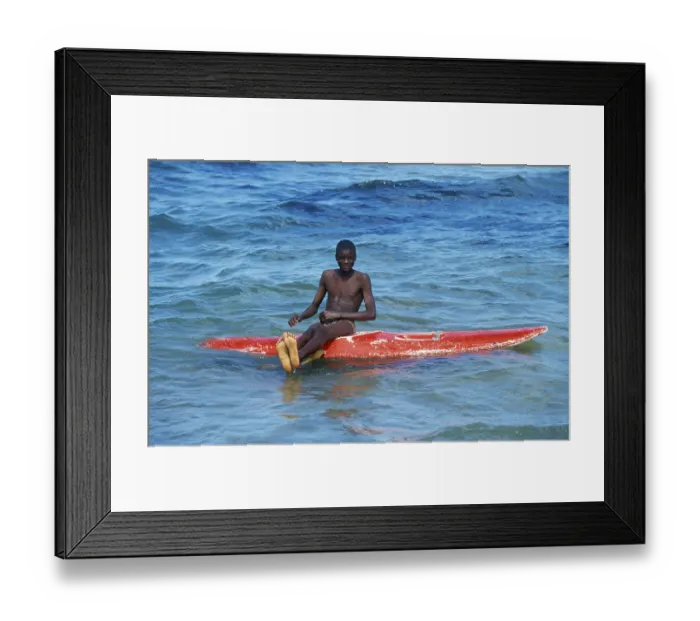 Framed Print : Teenager sitting on a surfboard in Lake Malawi Framed Print : Teenager sitting on a surfboard in Lake Malawi