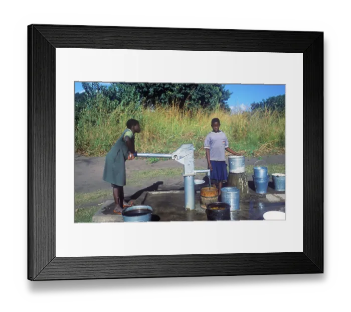 Framed Print : Two young woman at a well in a village near Kande on Lake Malawi Framed Print : Two young woman at a well in a village near Kande on Lake Malawi