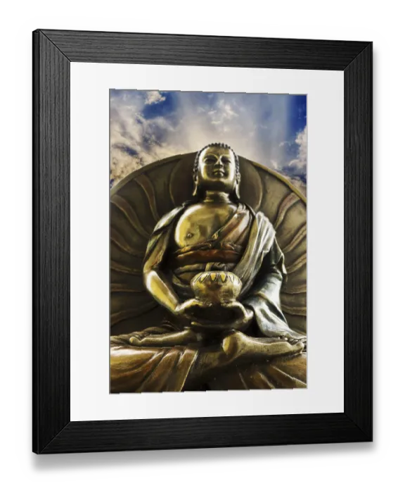 Framed Print : Brass Buddha statue with a serene expression under a cloudy sky Framed Print : Brass Buddha statue with a serene expression under a cloudy sky