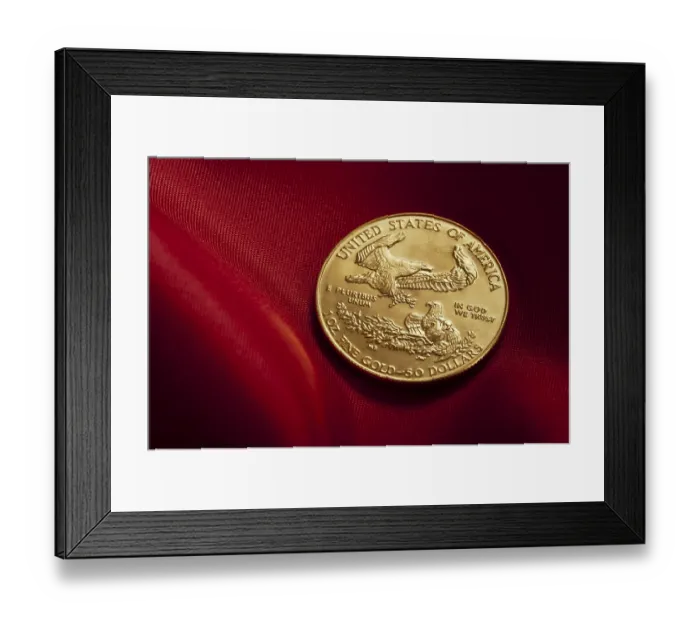 Framed Print : Gold coin with eagle design placed on rich red fabric