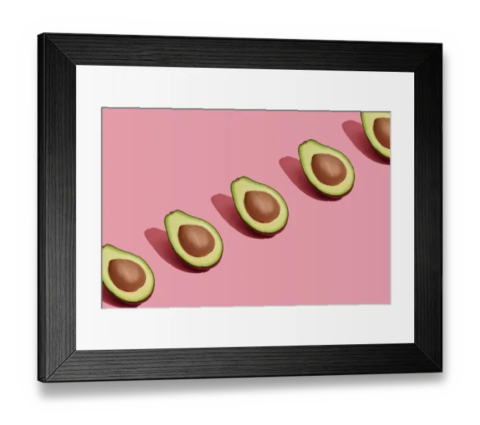 Framed Print : Food design. Top view of colorful fruit pattern of fresh cutted avocado halves with pits inside on coral pink pastel