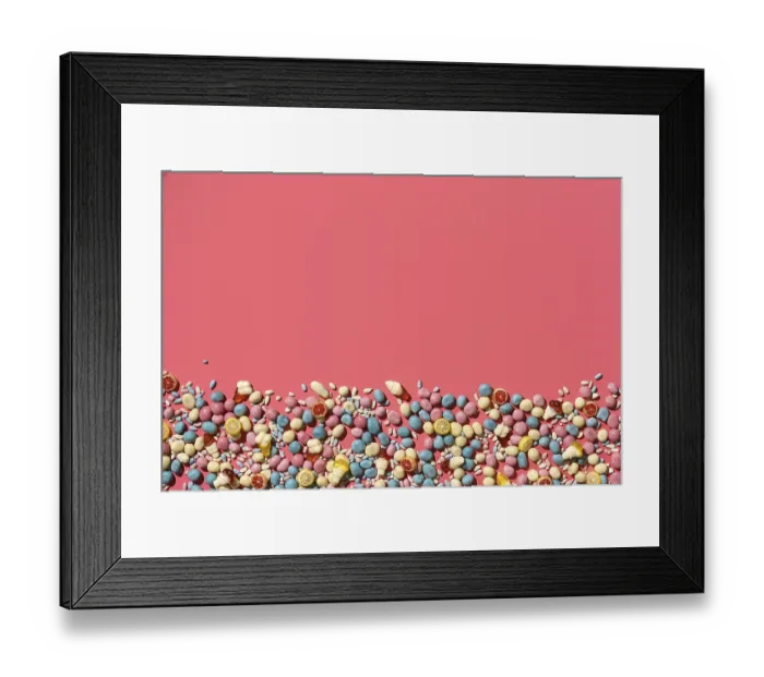 Framed Print : Various sweets, candys are palced on the bottom part of the photo on the coral background