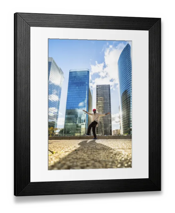 Framed Print : Stylish black man balancing on one leg with outstretched arms