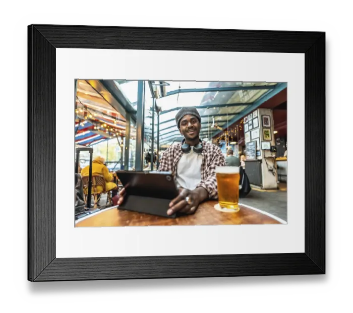 Framed Print : Young black man in a plaid shirt and hat