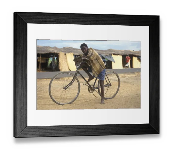 Framed Print : Boy with bicycle in front of a street market Framed Print : Boy with bicycle in front of a street market