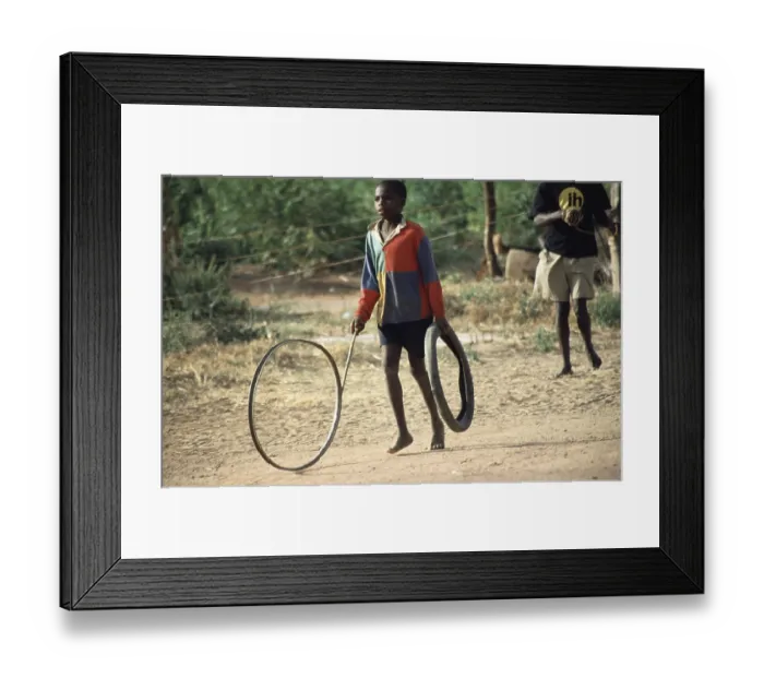 Framed Print : Boy playing with tires, Salima Framed Print : Boy playing with tires, Salima