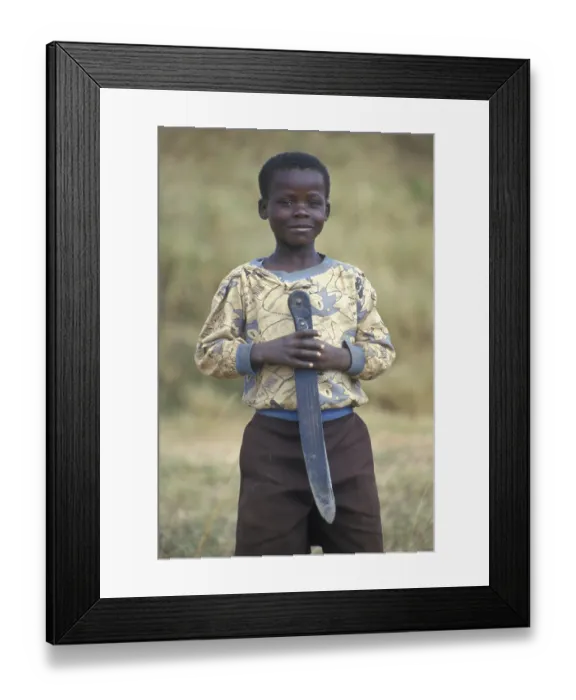 Framed Print : Portrait of a little boy with a big knife