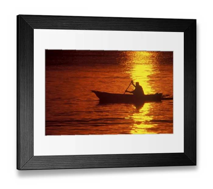 Framed Print : Silhouette of a fisherman in his boat at sunrise near Mikadi Beach