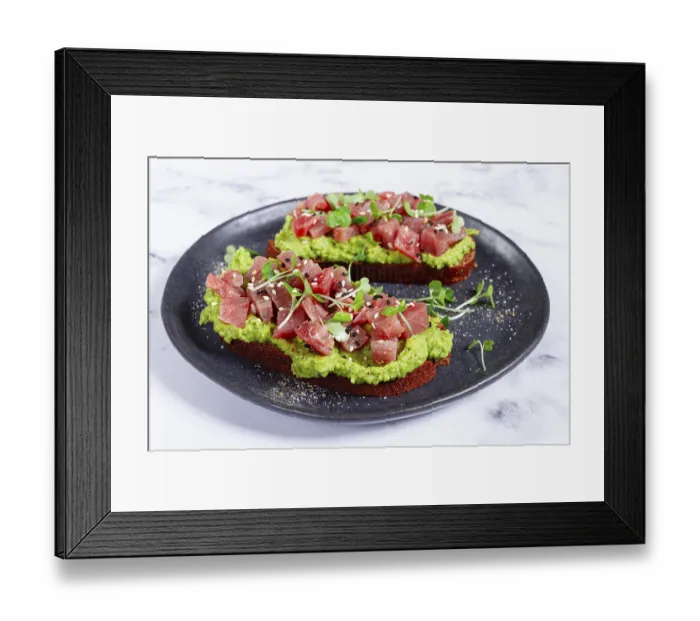 Framed Print : Fresh tuna tartare on avocado spread toast with microgreens served on a black plate