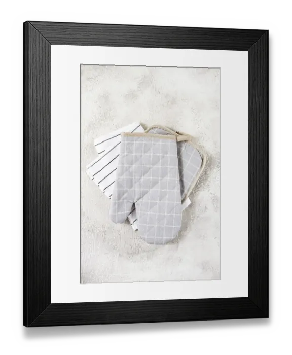 Framed Print : Gray checkered oven mitts and simple kitchen towels are neatly arranged on a soft Framed Print : Gray checkered oven mitts and simple kitchen towels are neatly arranged on a soft