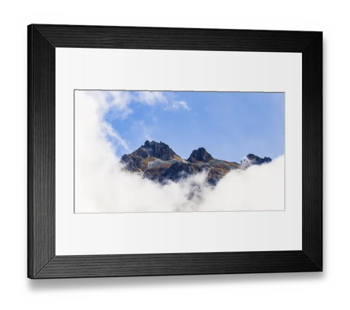 Framed Print : Mountain peaks rising out of fog