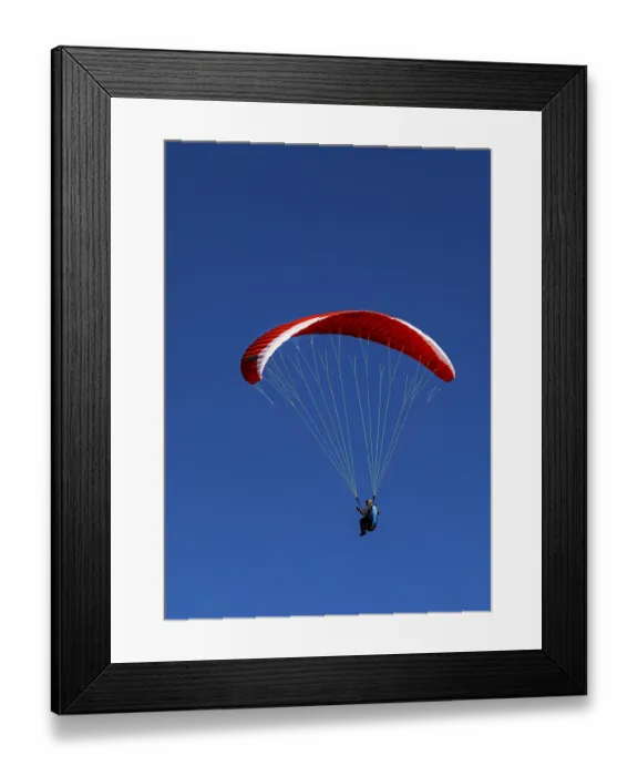 Framed Print : Paragliders against a blue sky