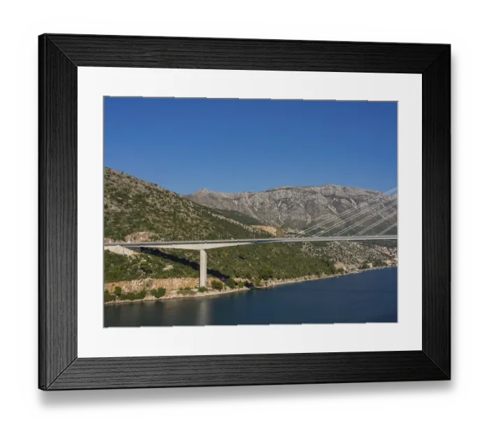 Framed Print : Modern bridge across a river nestled in a mountainous landscape Framed Print : Modern bridge across a river nestled in a mountainous landscape