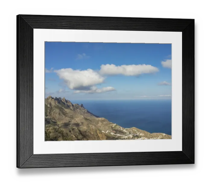 Framed Print : Wide view over mountains to the deep blue sea under a sky with scattered clouds Framed Print : Wide view over mountains to the deep blue sea under a sky with scattered clouds