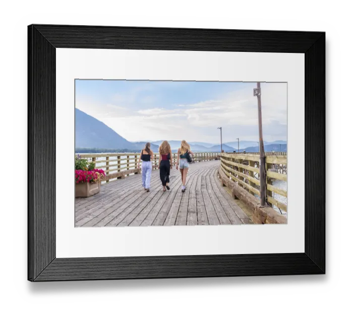 Framed Print : Three young women are enjoying a leisurely stroll along a scenic wooden pier in salmon arm Framed Print : Three young women are enjoying a leisurely stroll along a scenic wooden pier in salmon arm