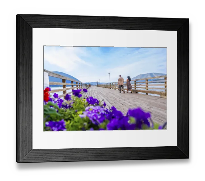 Framed Print : Tourists walking on a wooden pier adorned with vibrant flowers
