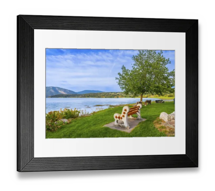 Framed Print : Scenic view of shuswap lake with a bench in the foreground