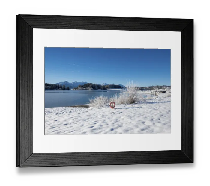 Framed Print : Snowy lake with a clear view of distant mountains