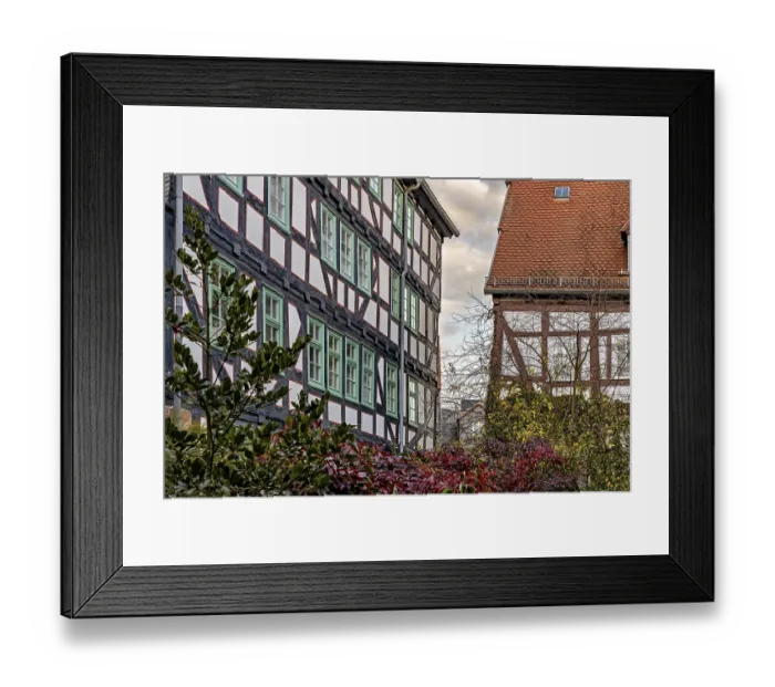 Framed Print : Half-timbered houses with green shutters and autumn vegetation Framed Print : Half-timbered houses with green shutters and autumn vegetation