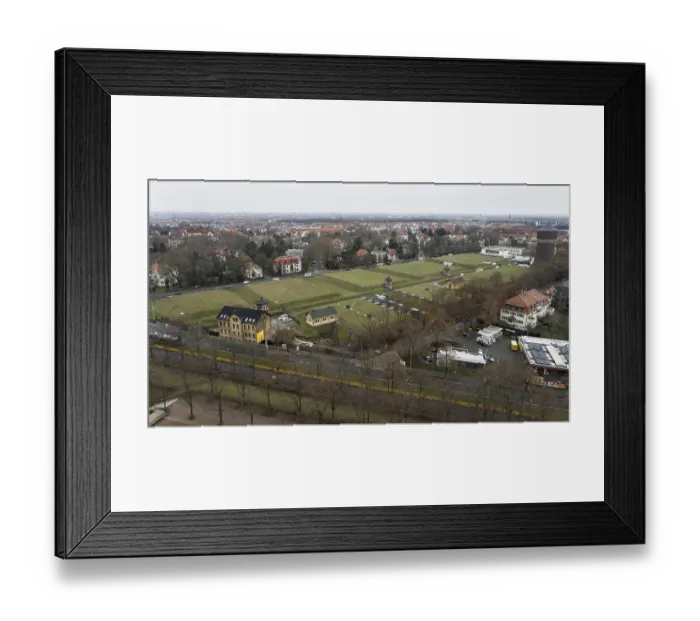 Framed Print : Wide-angle view of an urban area with a central water tower and surrounding green spaces
