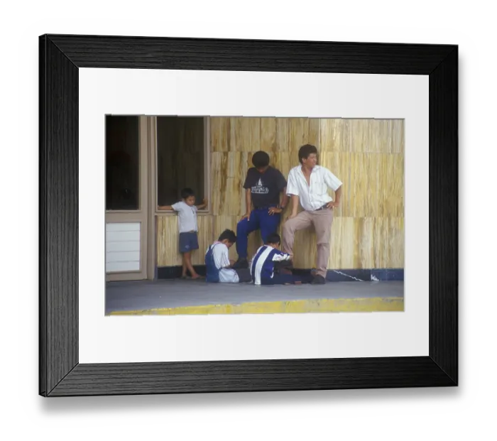 Framed Print : Young shoe cleaner at work in Iquitos