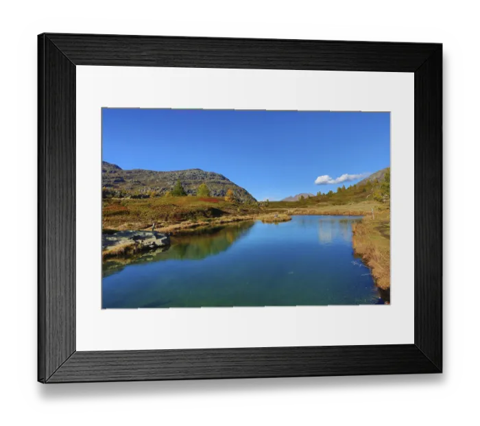 Framed Print : Mountain lake with calm water and surrounding hills under a cloudless sky