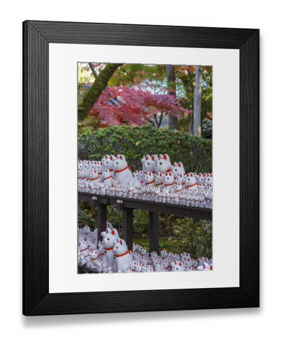 Framed Print : Various maneki-neko statues in a Japanese garden in autumn