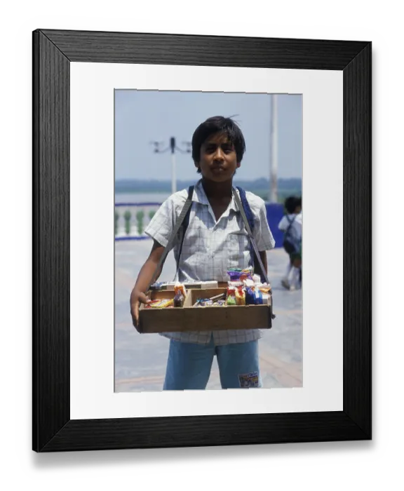 Framed Print : Boy with belly shop selling sweets in Iquitos
