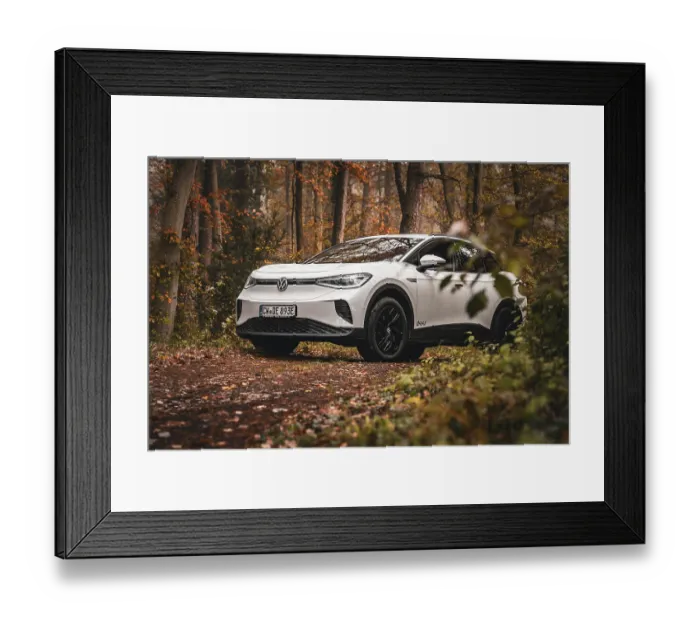 Framed Print : White car parked in forest surrounded by autumn leaves