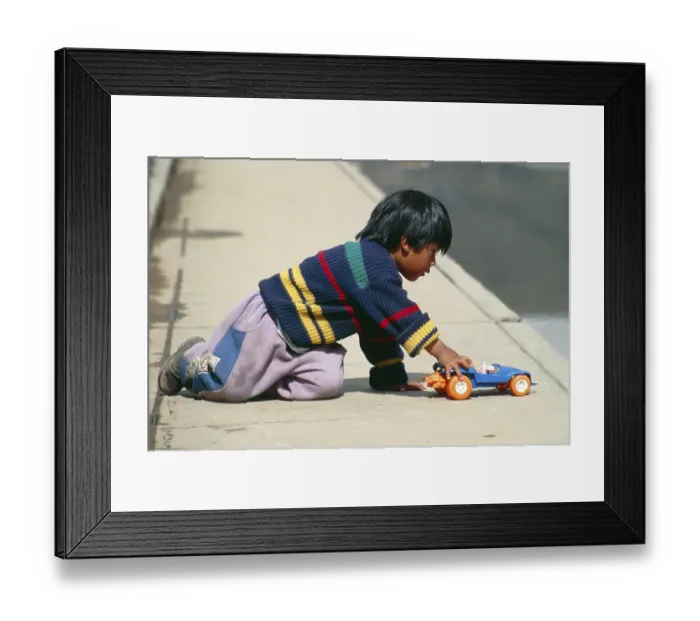 Framed Print : Little boy playing with toy car Framed Print : Little boy playing with toy car