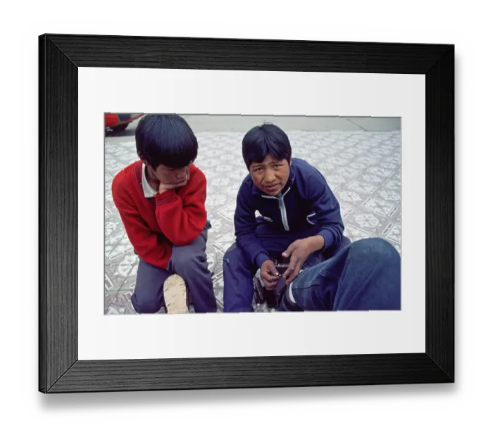 Framed Print : Teenager, young shoe cleaner at work